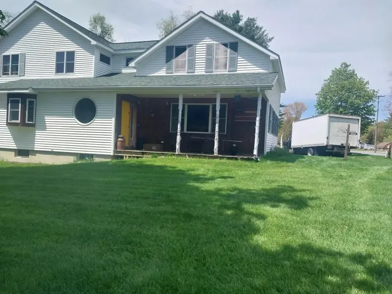 Gutters and exterior refresh on a two-story farmhouse